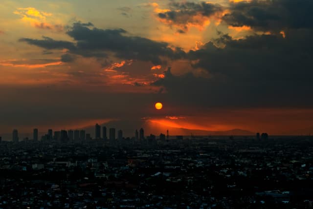 Captivating view of Manila skyline under dramatic sunset clouds.