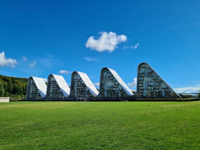 Modern architectural marvel, the Wave in Vejle, Denmark against a clear summer sky.