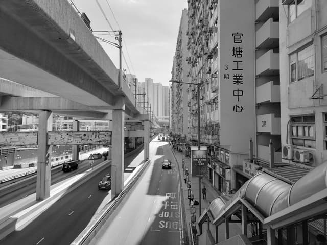 Black and white view of an urban street with modern architecture in Kwun Tong, Hong Kong.