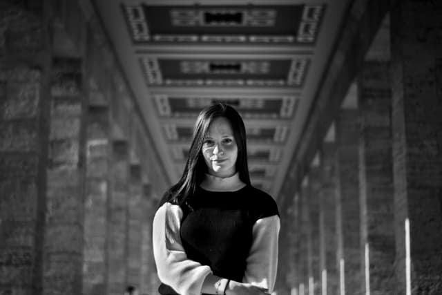 A striking black and white portrait of a woman standing at Anıtkabir, Ankara.