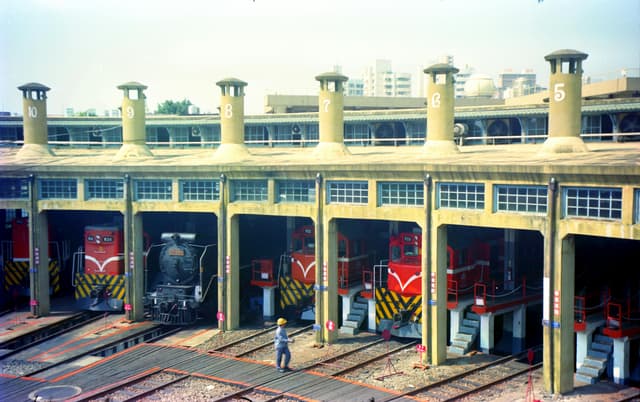 Aerial view of train roundhouse in Changhua City, Taiwan with locomotives and roundhouse structure.
