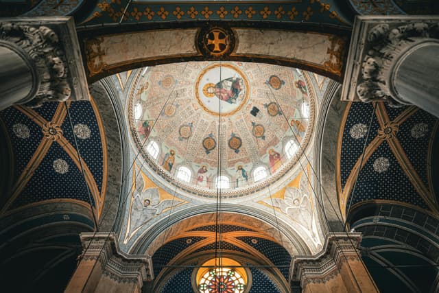 Detailed view of a beautifully adorned dome inside a historic church in Istanbul, reflecting rich religious art and architecture.