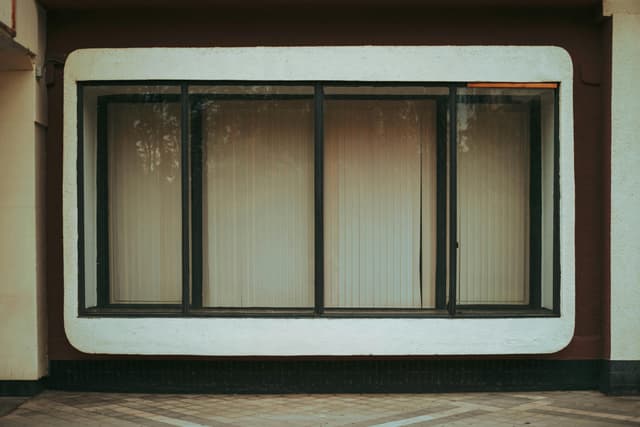 Contemporary window with blinds on a building facade, showcasing architectural design in Krasnodar.