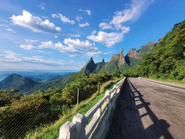 Majestic mountain view from a highway in Brazil under a clear blue sky.