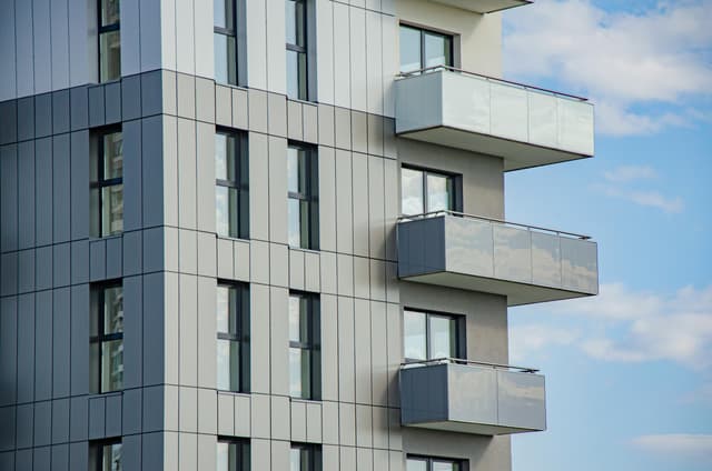 Contemporary architecture featuring balconies and glass windows on a sunny day in Rzeszów.
