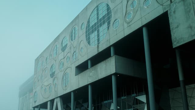 Foggy view of Musikkens Hus in Aalborg, Denmark showcasing modern design.