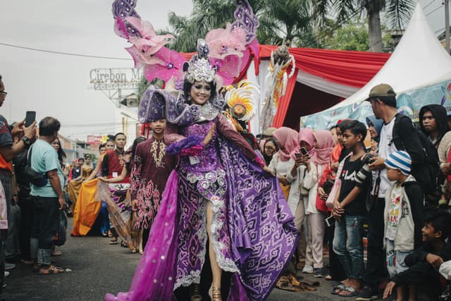Vibrant street festival in West Java, showcasing traditional Indonesian costumes and cultural diversity.