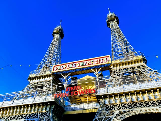 A modern replica of Eiffel Towers in Bhopal's People's Smart City under a clear blue sky.