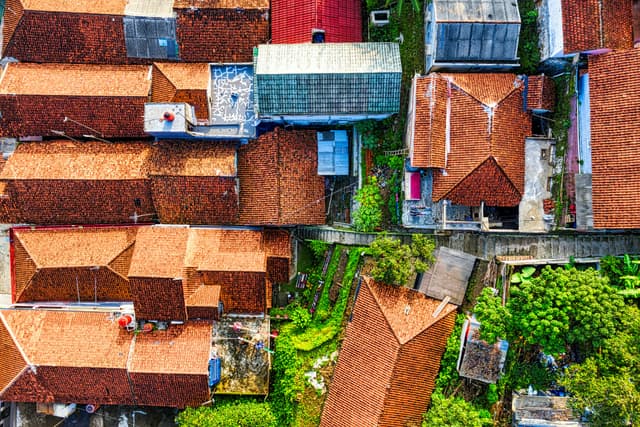 Vibrant aerial shot of traditional rooftops in a West Java village, Indonesia.
