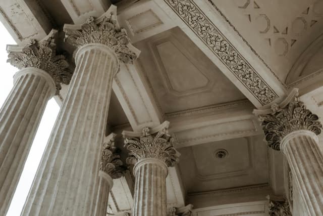 Low-angle view of ornate Corinthian columns showcasing intricate classical architecture.