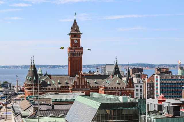 Aerial view of Helsingborg City Hall with its iconic clock tower and ocean backdrop in Sweden.