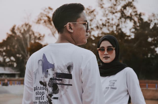 Portraits of two adults wearing sunglasses and casual attire outdoors in Bandar Lampung, Indonesia.