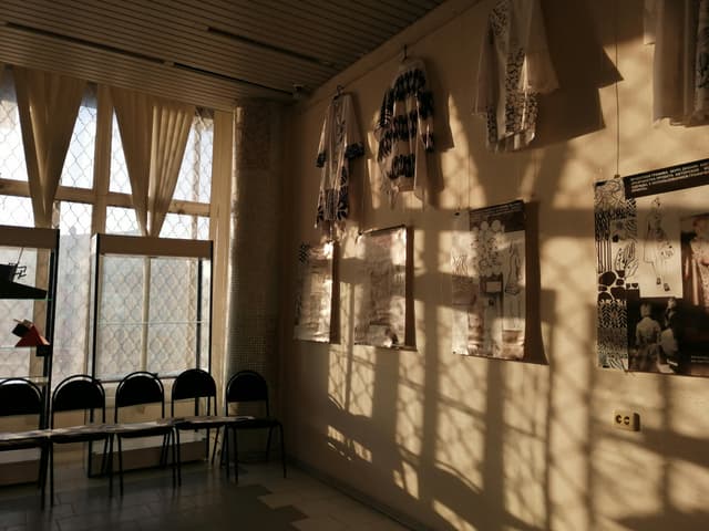 Sunlit interior featuring hanging art and shadows creating a serene atmosphere in Kursk, Russia.