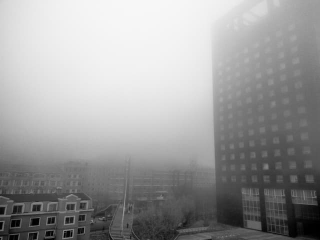 Foggy urban landscape with buildings and stairway in Dalian, China.